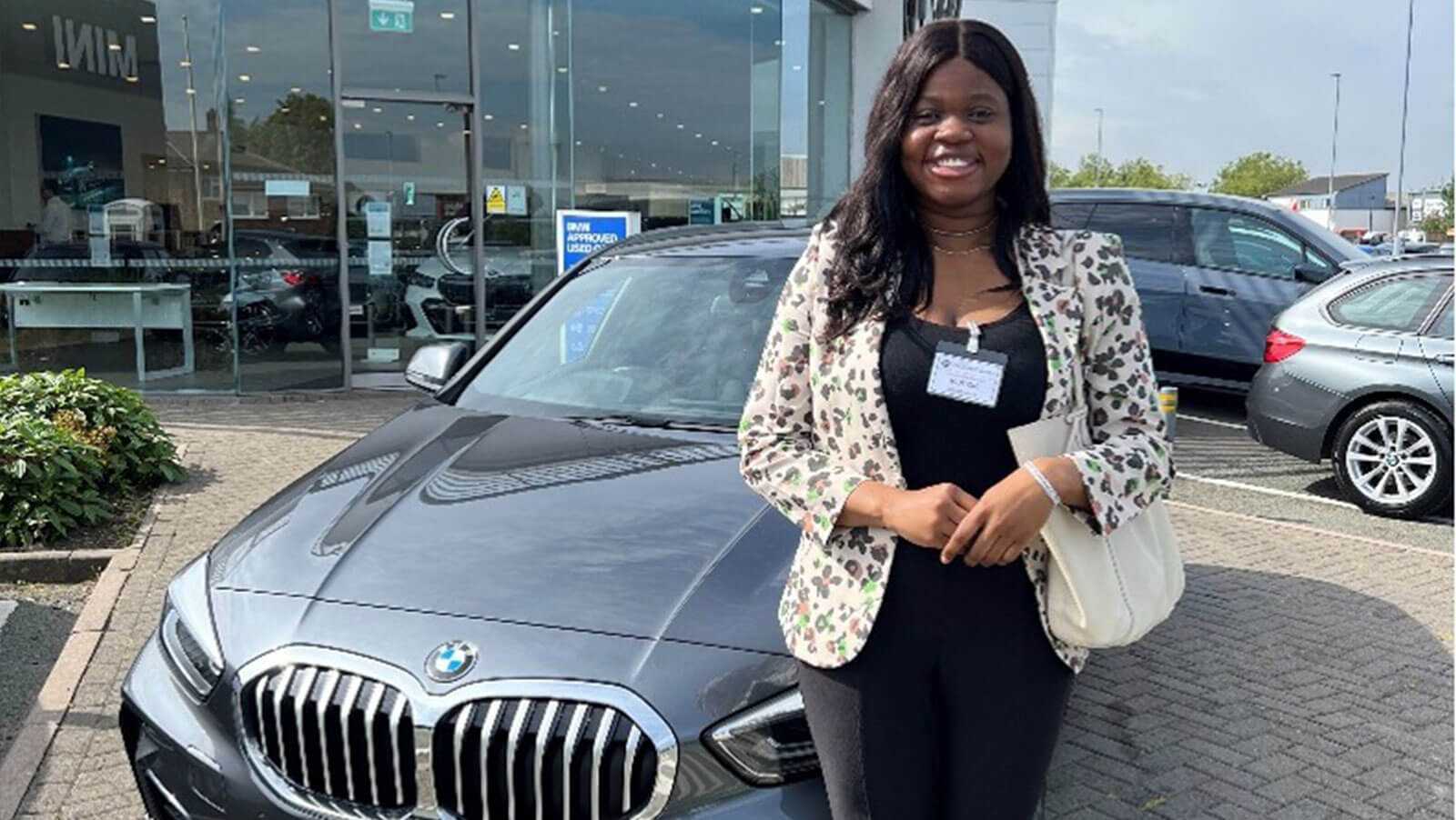 Picture of Moyosola at a car dealship Picture of Moyosola at a car dealship